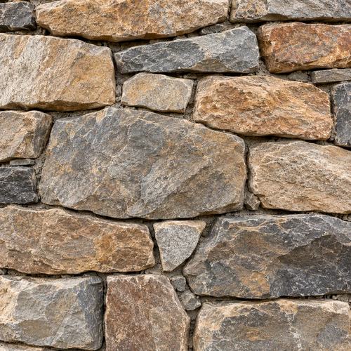 Close-up of a natural stone retaining wall with varied stone shapes